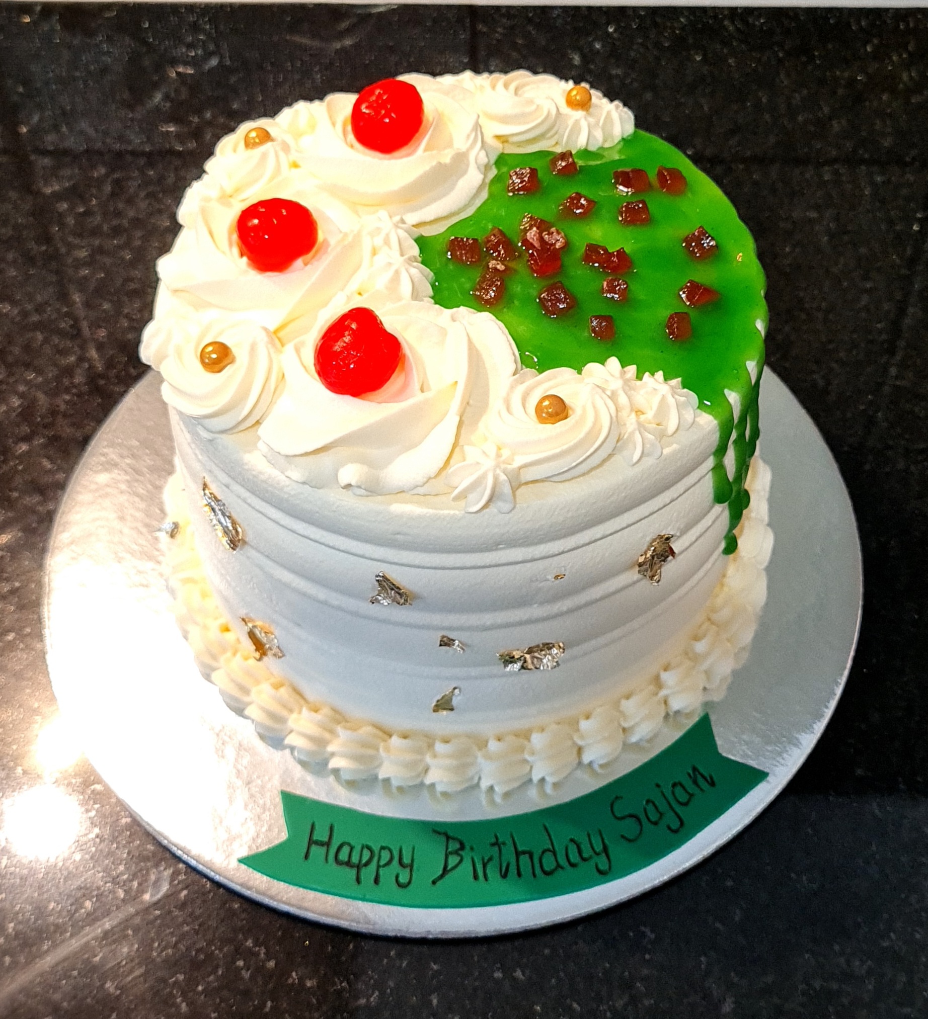 Indian Paan Fusion Cake with green paan drip, white cream rosettes and traditional elements for Sajan's birthday celebration
